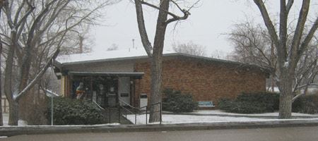 Snow covering the ground outside of a brick municipal building