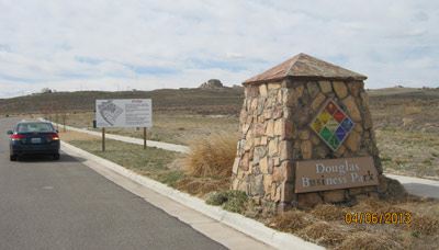 A car driving on a road next to a marker that says Douglas Business Park